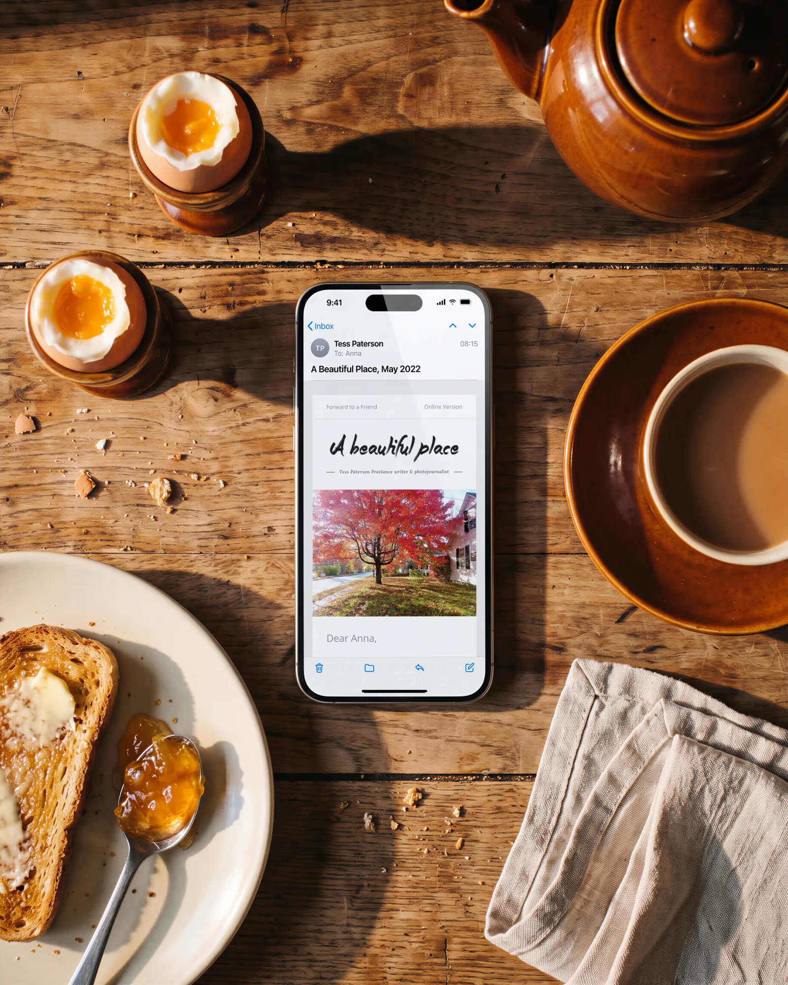 A Beautiful Place’s newsletter on a phone at breakfast, seen from above: soft-boiled eggs, toast and tea.