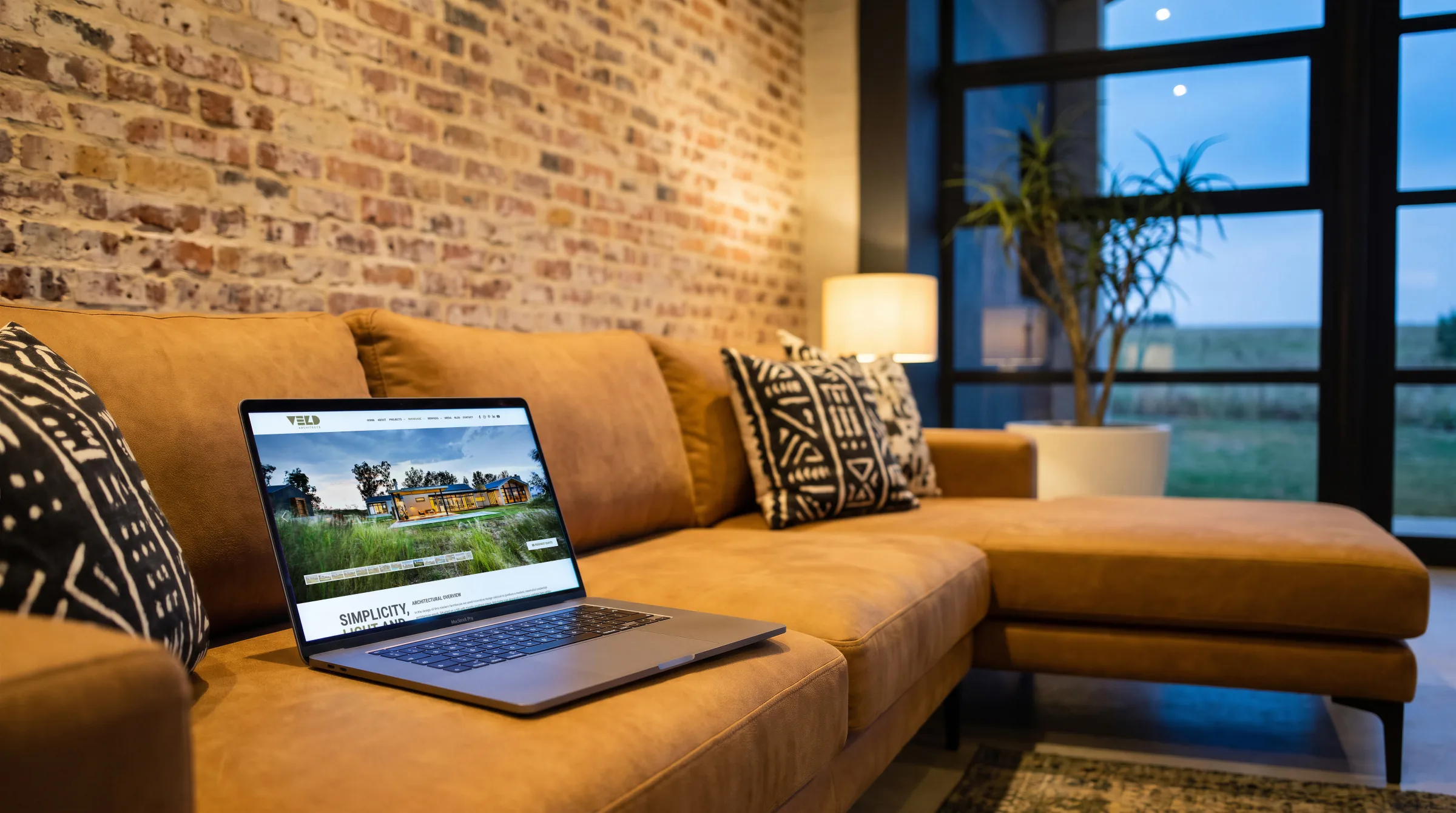 The site open on a tablet in a stone-walled living room, a fire lit.