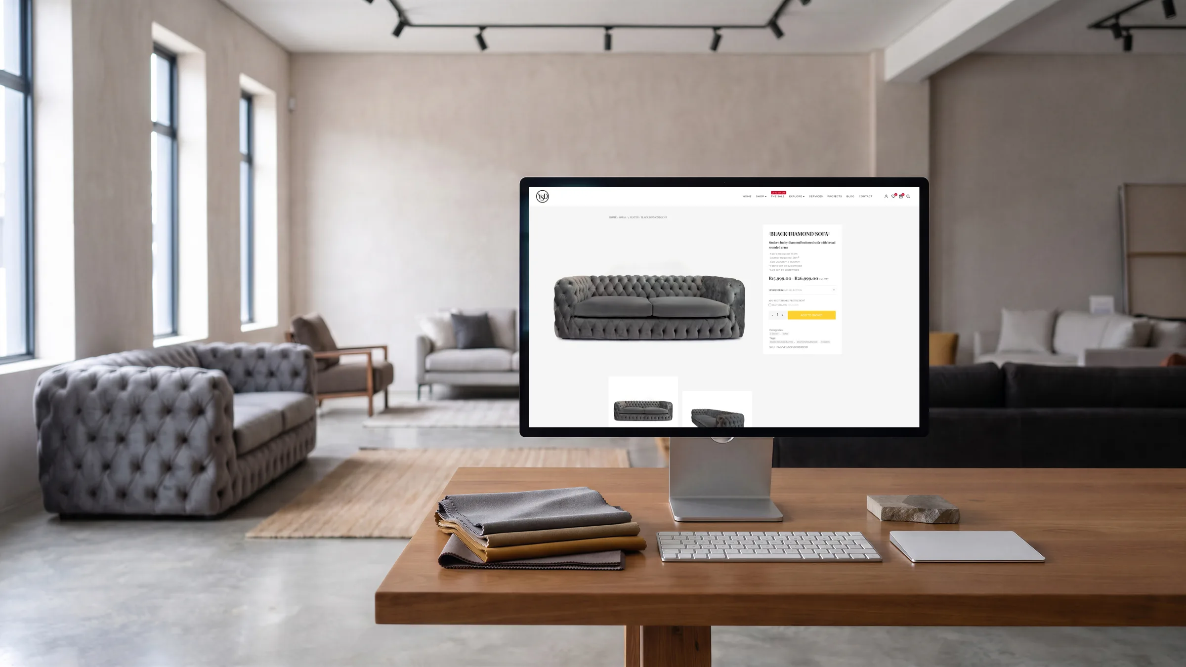 The Black Diamond Sofa page on a desktop in the showroom, grey sofas behind.